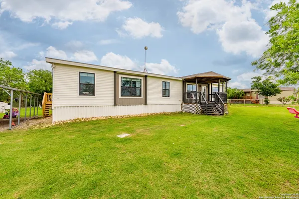 a view of a porch with furniture and garden