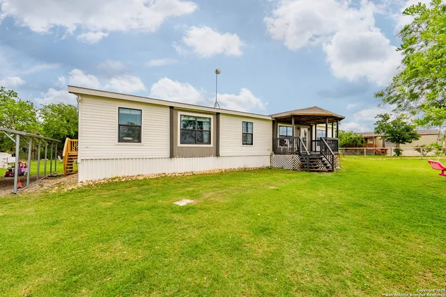 a view of a porch with furniture and garden