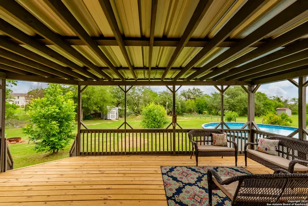 a view of a patio with table and chairs and wooden floor