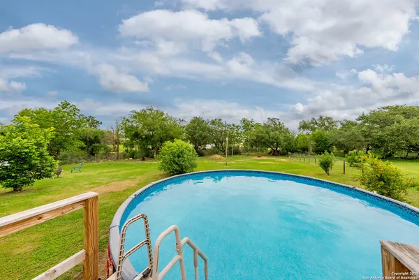 a view of swimming pool with an outdoor space and seating area