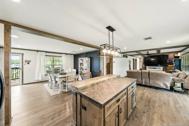 a dining room with furniture and wooden floor