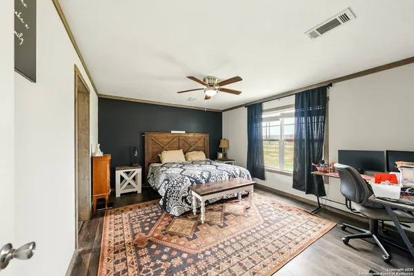 a bathroom with double vanity sinks a large mirror next to a window