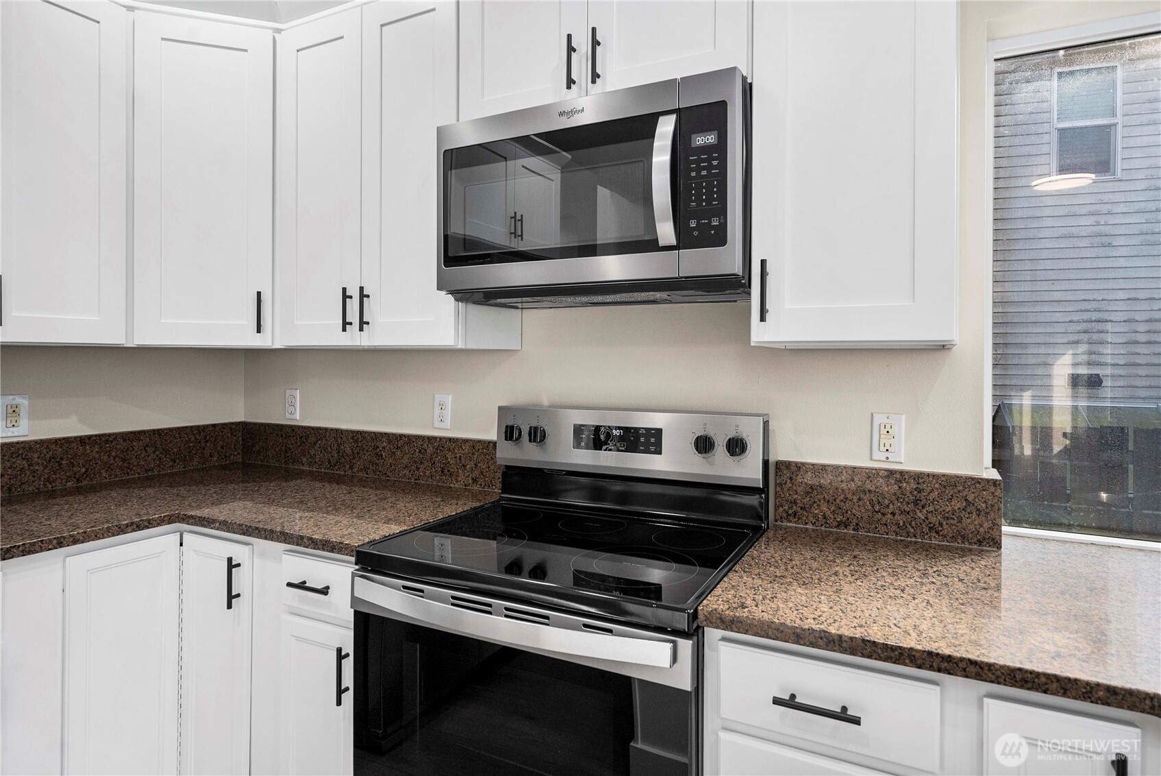 4125 South 220th Place, Unit 26 Kent, WA 98032 - Photo 11 of 39 a kitchen with stainless steel appliances granite countertop white cabinets and a stove top oven