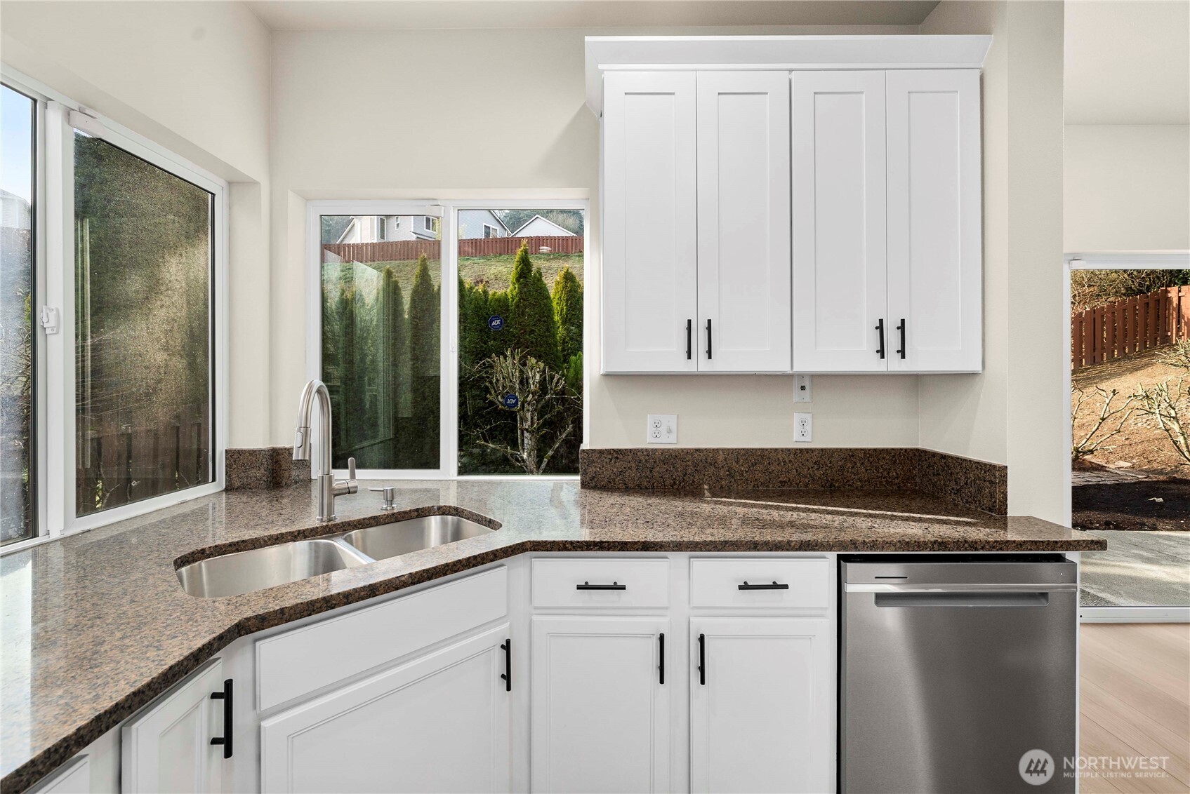 4125 South 220th Place, Unit 26 Kent, WA 98032 - Photo 12 of 39 a kitchen with granite countertop a sink window and cabinets