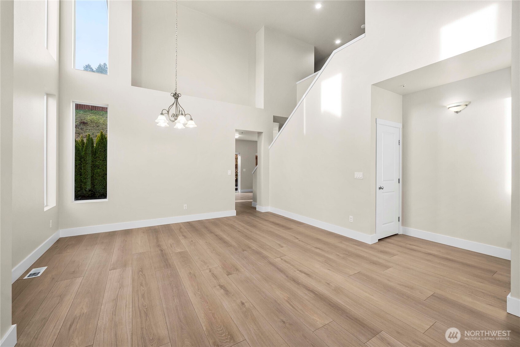 4125 South 220th Place, Unit 26 Kent, WA 98032 - Photo 7 of 39 a view of an empty room with wooden floor and staircase