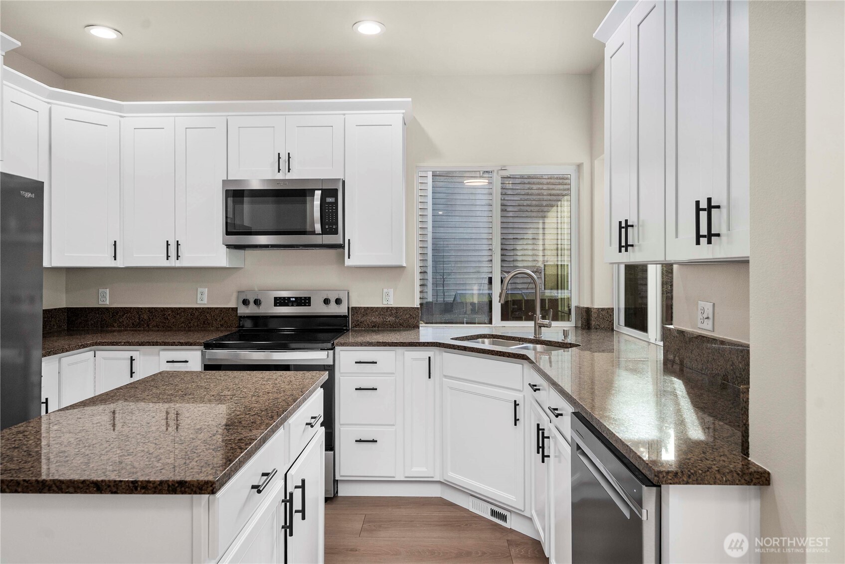 4125 South 220th Place, Unit 26 Kent, WA 98032 - Photo 9 of 39 a kitchen with stainless steel appliances granite countertop a sink stove and cabinets