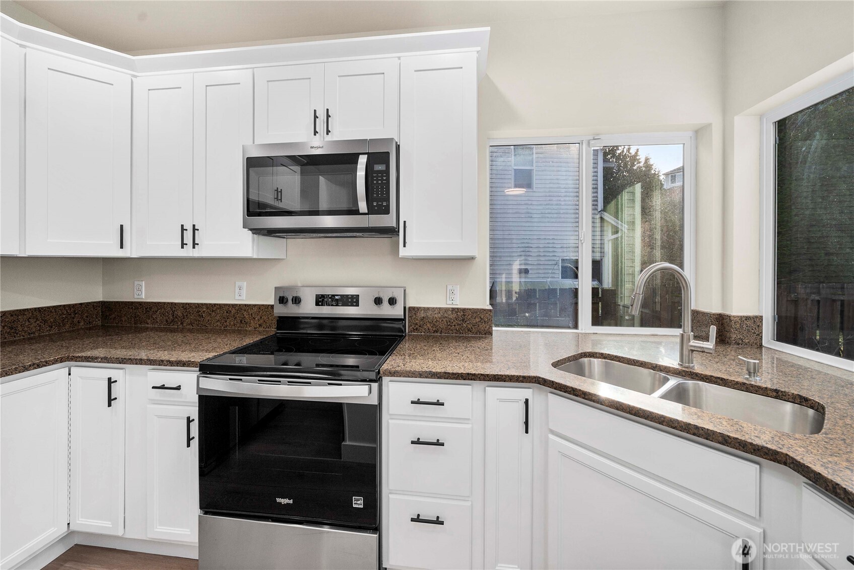 4125 South 220th Place, Unit 26 Kent, WA 98032 - Photo 10 of 39 a kitchen with stainless steel appliances granite countertop a sink stove and microwave