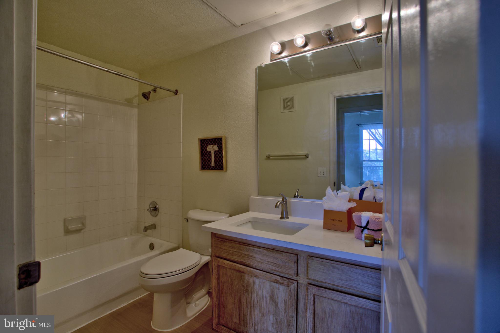 1570 Spring Gate Dr., Unit 7215 McLean, VA 22102 - Photo 12 of 30 a bathroom with a sink a toilet and shower