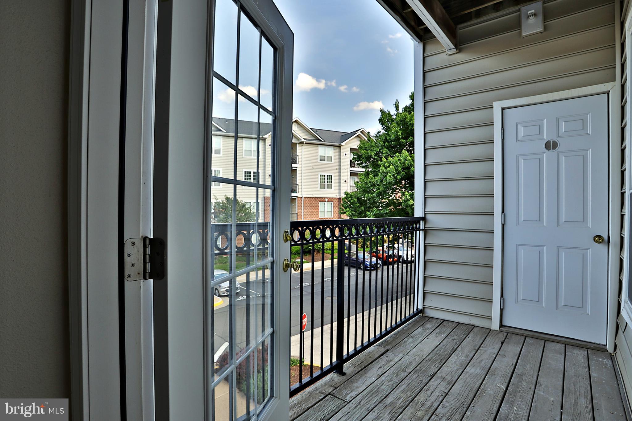 1570 Spring Gate Dr., Unit 7215 McLean, VA 22102 - Photo 14 of 30 a view of a balcony with wooden floor