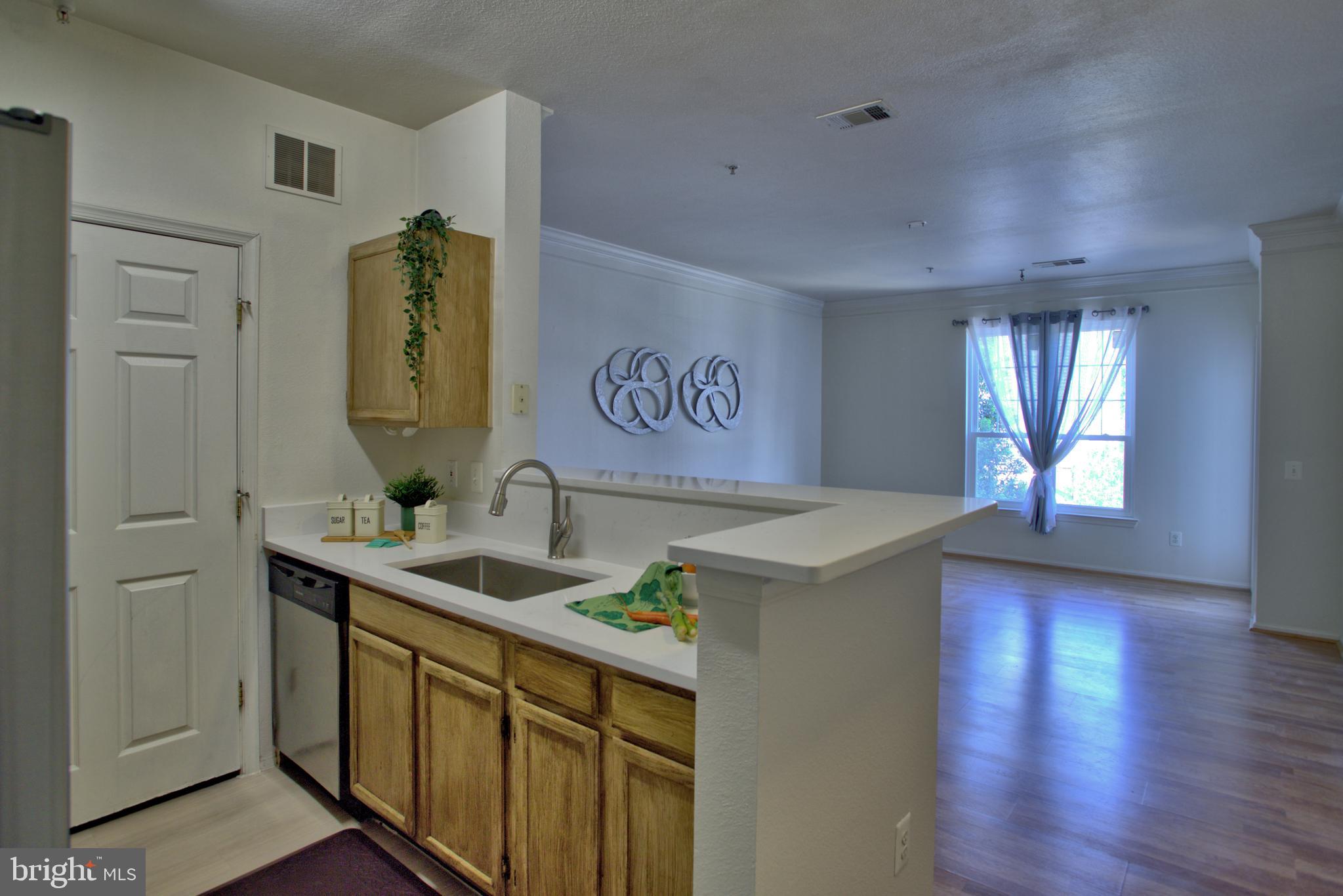 1570 Spring Gate Dr., Unit 7215 McLean, VA 22102 - Photo 2 of 30 a view of a kitchen with a sink and a wooden floor