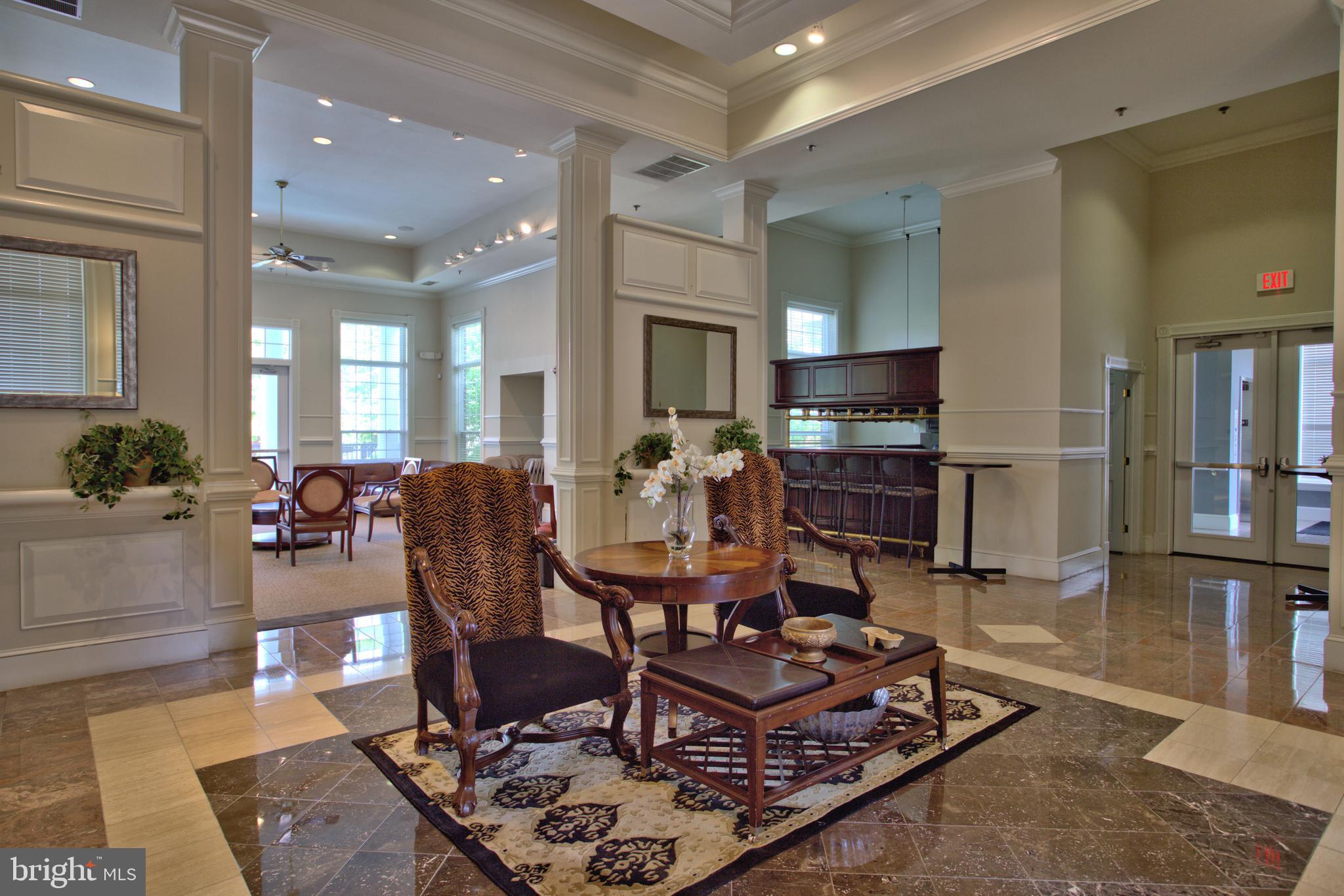 1570 Spring Gate Dr., Unit 7215 McLean, VA 22102 - Photo 22 of 30 a living room with furniture and a flat screen tv