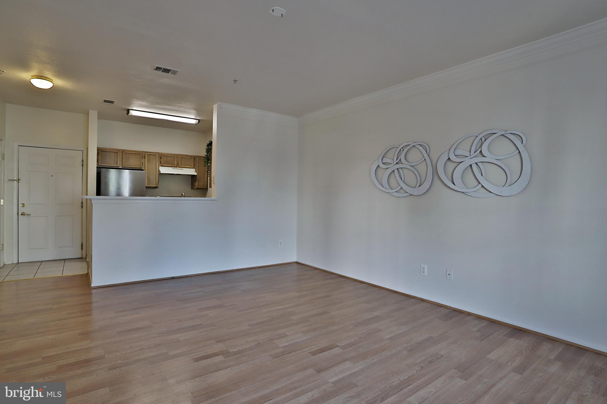 1570 Spring Gate Dr., Unit 7215 McLean, VA 22102 - Photo 7 of 30 a view of a hallway with wooden floor