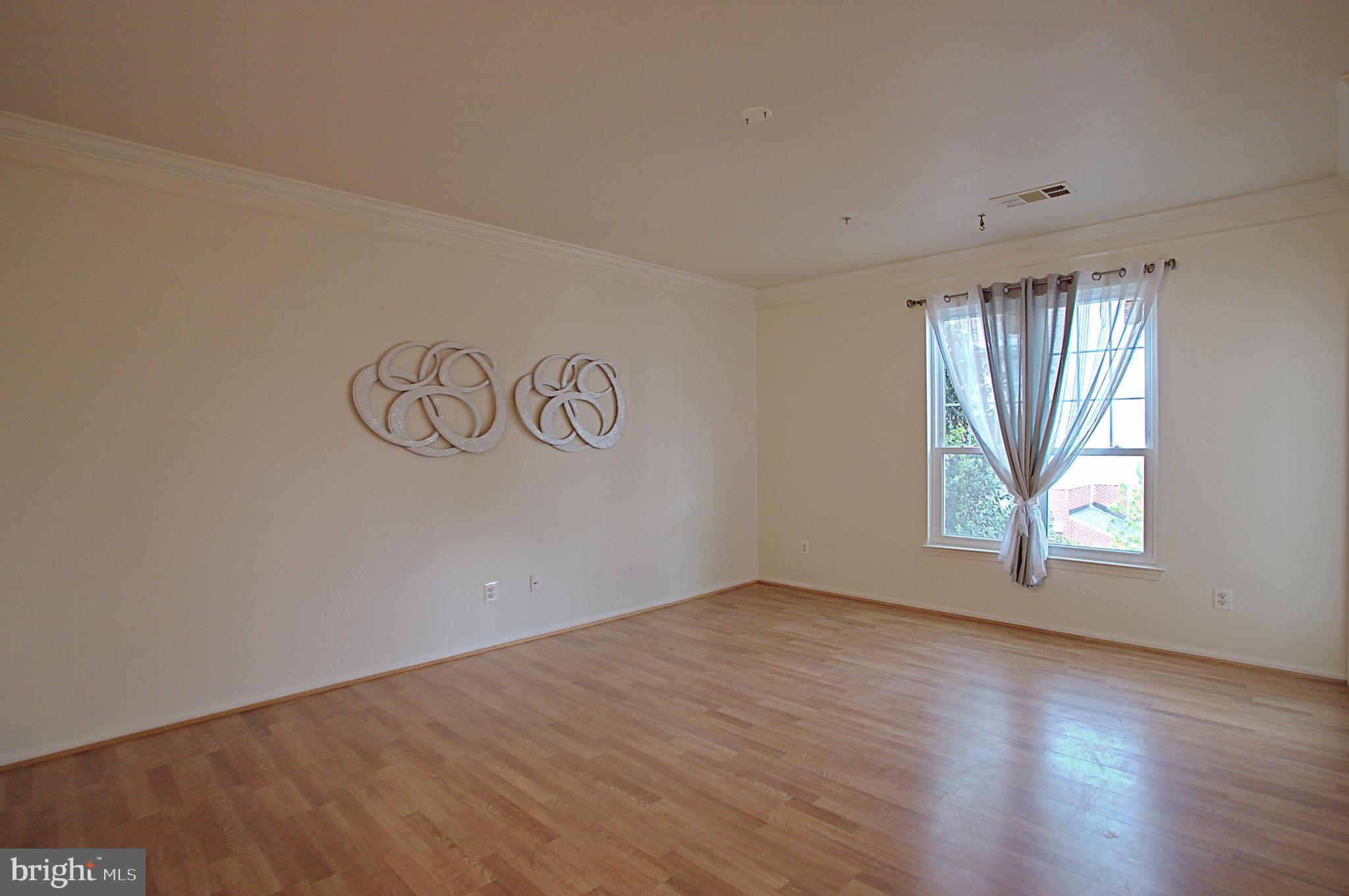 1570 Spring Gate Dr., Unit 7215 McLean, VA 22102 - Photo 8 of 30 an empty room with windows
