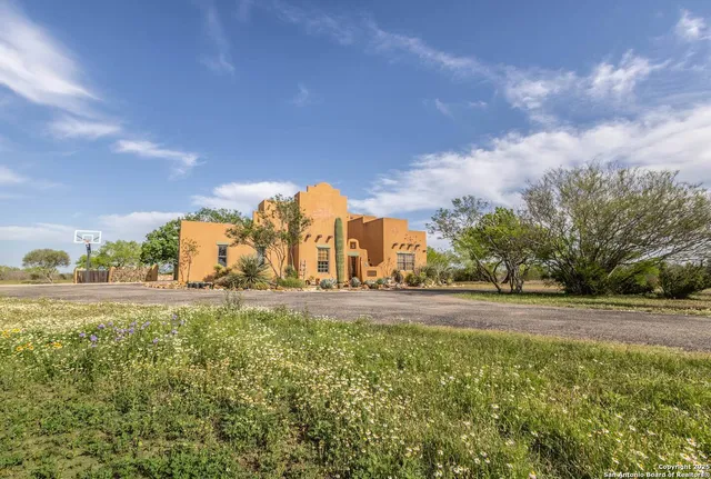 a view of a fountain in middle of the green field