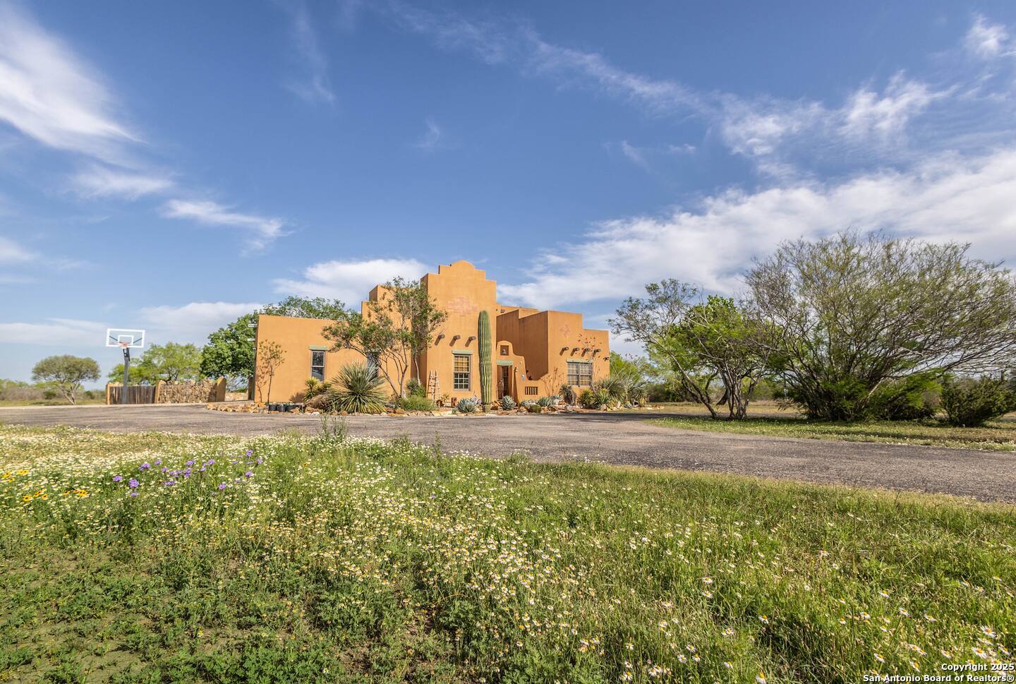 a view of a fountain in middle of the green field