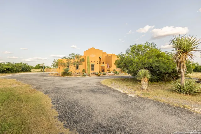 a view of a door with a chair and a potted plant