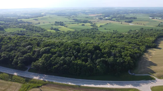 an aerial view of a houses with a yard