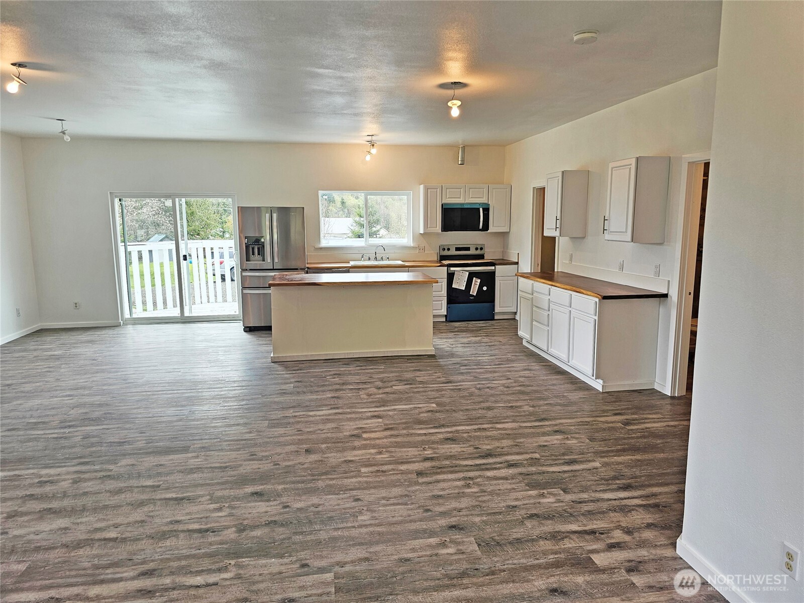 113 Leroy Road Randle, WA 98377 - Photo 18 of 40 a kitchen with stainless steel appliances wooden floor and large window