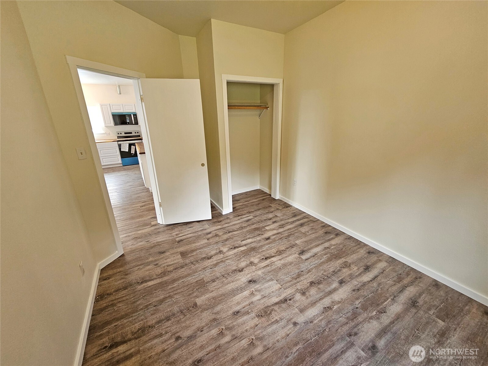 113 Leroy Road Randle, WA 98377 - Photo 21 of 40 a view of an empty room with wooden floor and a cabinet