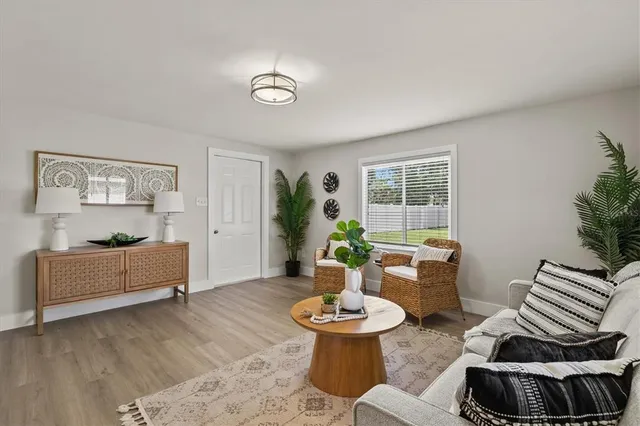 a living room with furniture and a dining table with kitchen view