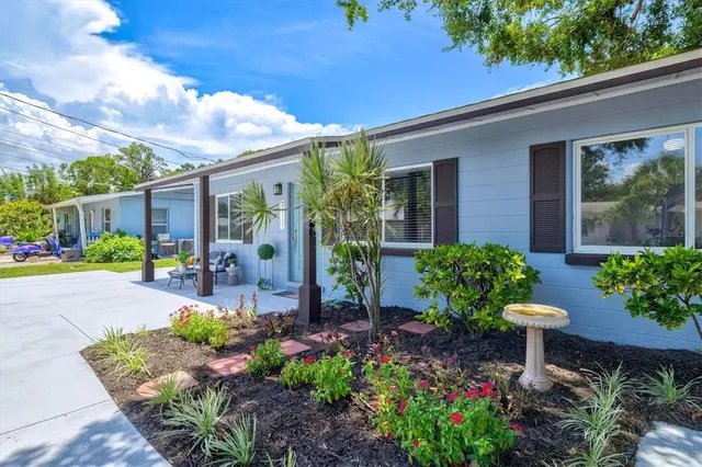 a view of a patio with chairs and potted plants