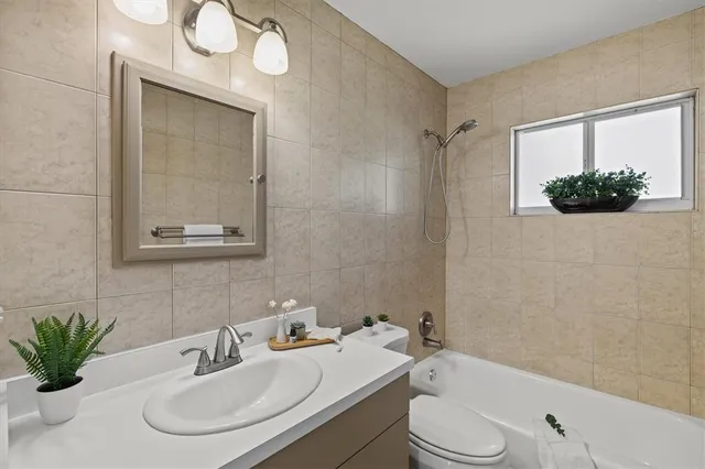 a view of a house with a yard and a tree