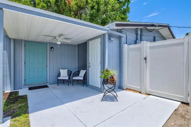 a view of an house with backyard and a tree