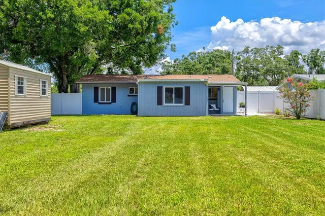 an aerial view of residential houses with outdoor space and street view