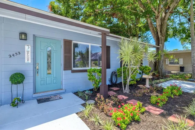 a view of a hallway with wooden floor and a potted plant