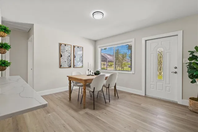 a view of a dining room with furniture and wooden floor