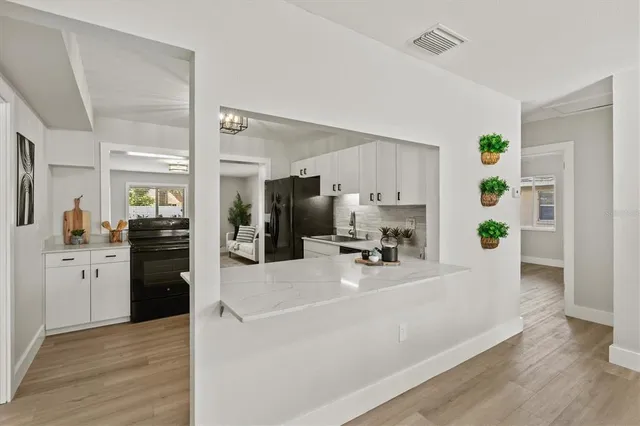 a kitchen with a refrigerator and a stove top oven