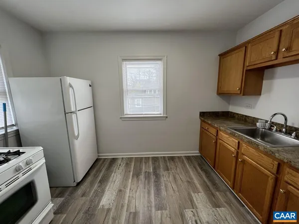 a kitchen with sink a refrigerator and a stove