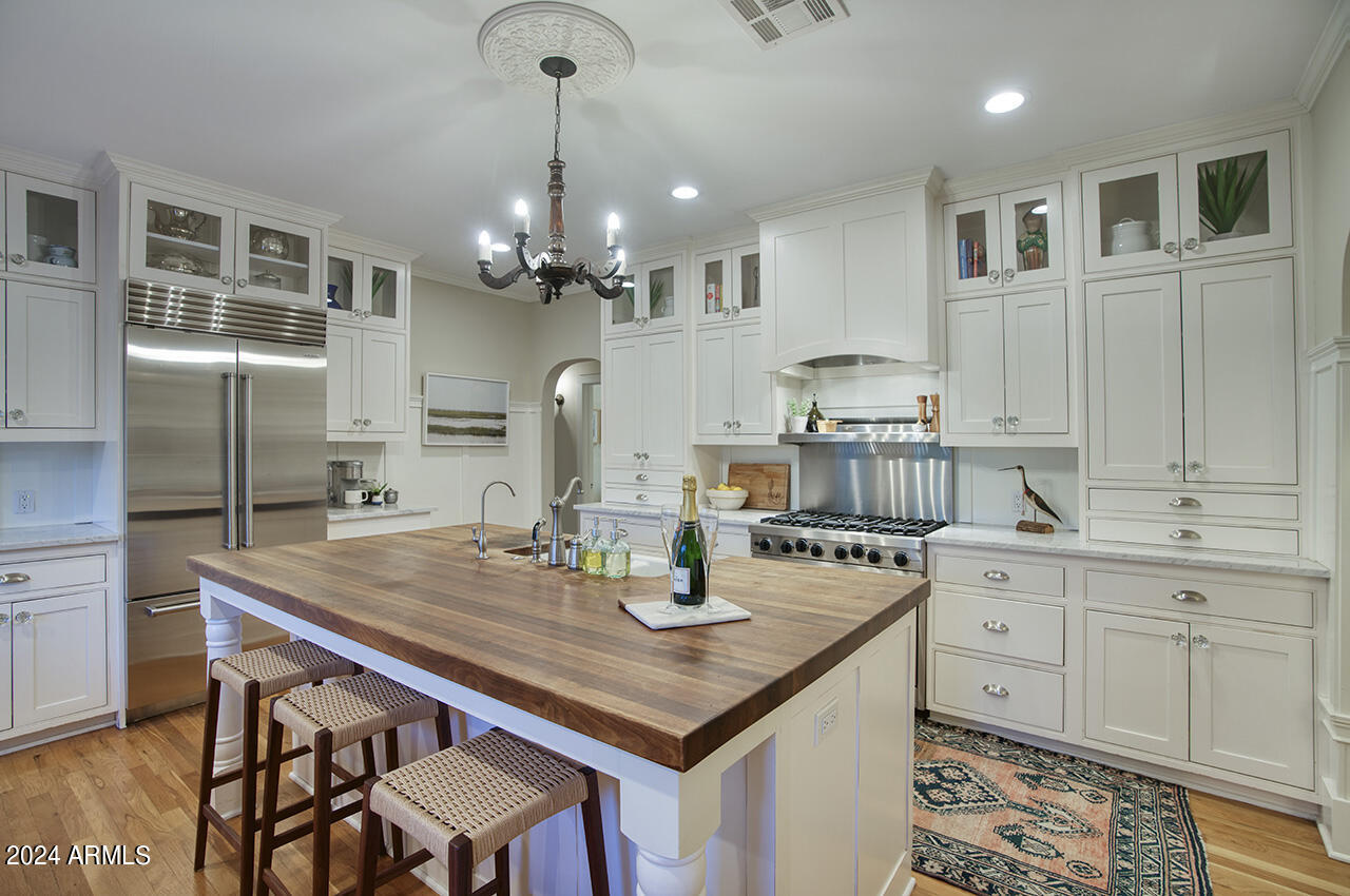 324 West Monte Vista Road Phoenix, AZ 85003 - Photo 12 of 39 a kitchen with granite countertop a table chairs stainless steel appliances and cabinets