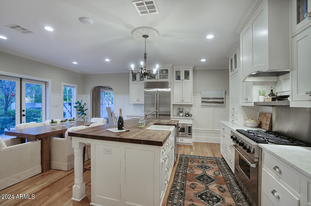 324 West Monte Vista Road Phoenix, AZ 85003 - Photo 14 of 39 a kitchen with stainless steel appliances granite countertop a sink stove and cabinets