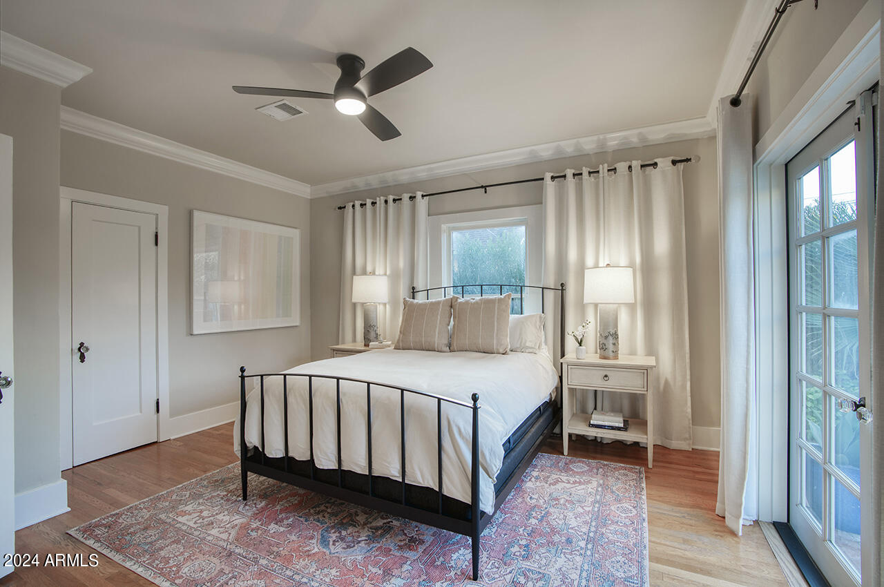 324 West Monte Vista Road Phoenix, AZ 85003 - Photo 20 of 39 a bedroom with a bed and a chandelier