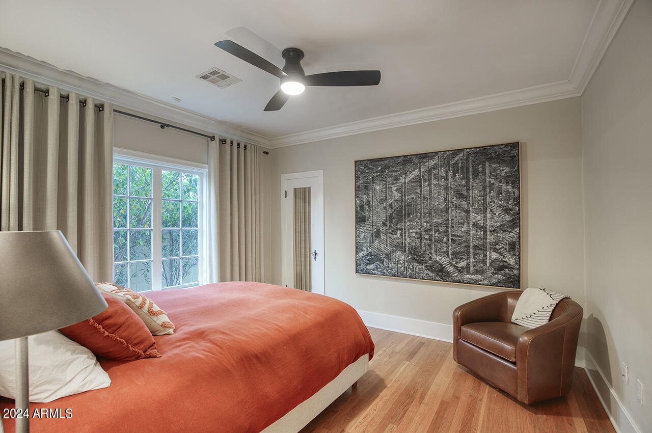 324 West Monte Vista Road Phoenix, AZ 85003 - Photo 23 of 39 a blue bed sitting in a bedroom next to a window