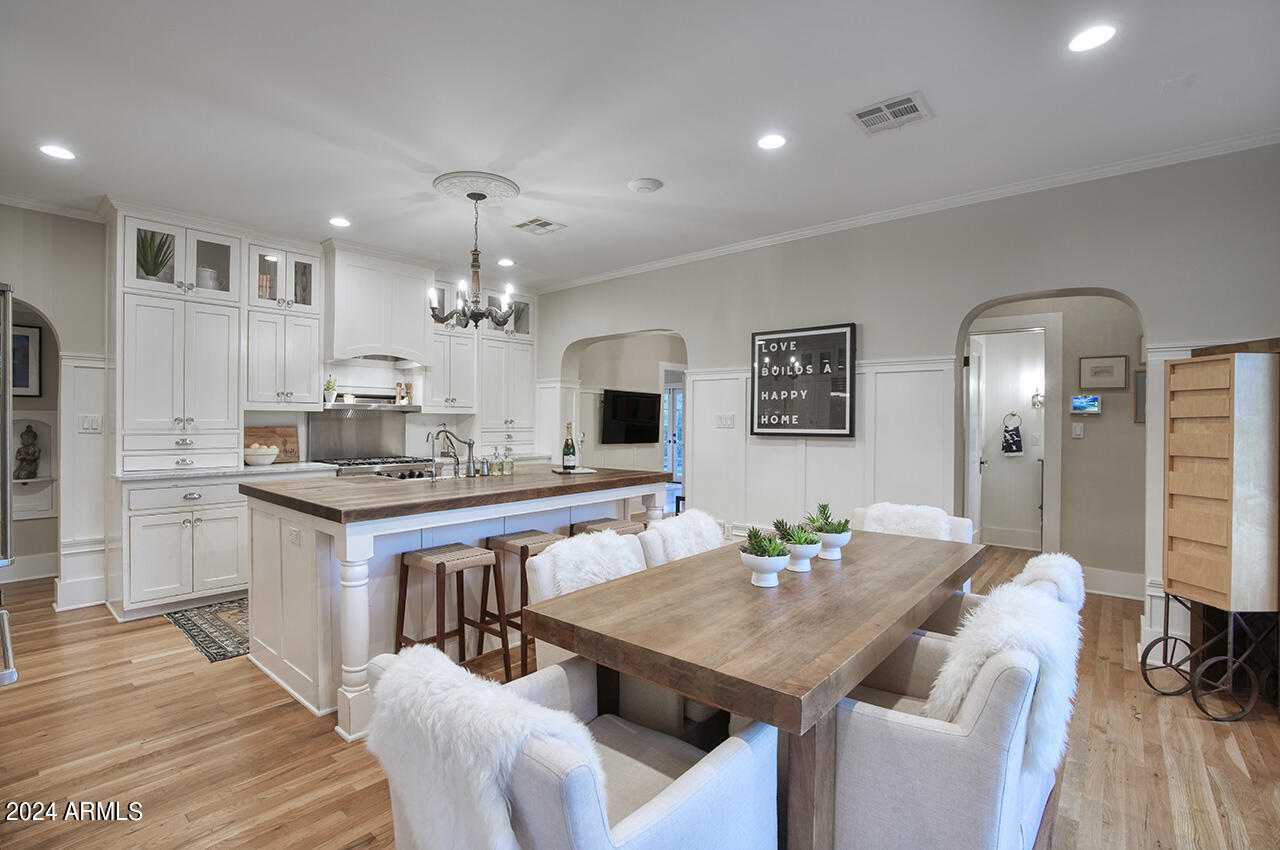 324 West Monte Vista Road Phoenix, AZ 85003 - Photo 9 of 39 a view of a dining room with furniture and wooden floor