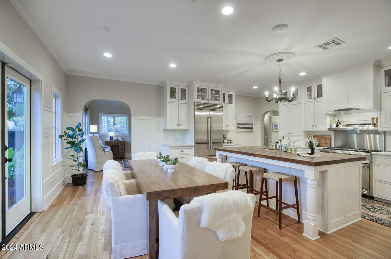324 West Monte Vista Road Phoenix, AZ 85003 - Photo 10 of 39 a view of a dining room with furniture and wooden floor