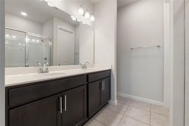 a bathroom with a double vanity sink and a mirror