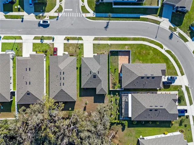 an aerial view of houses with outdoor space and swimming pool