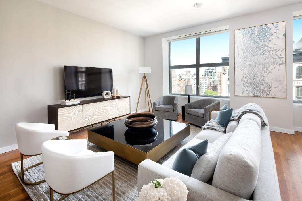 240 Park Avenue South, Unit 14B Manhattan, NY 10003 - Photo 2 of 12 a living room with furniture and a flat screen tv