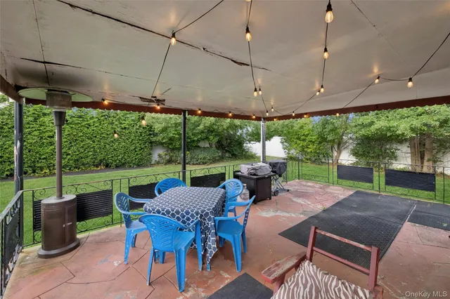 a view of a house with backyard and sitting area