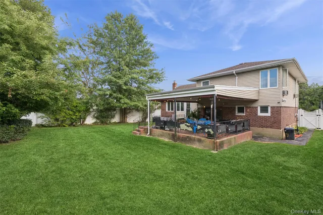 a view of a house with a yard and sitting area