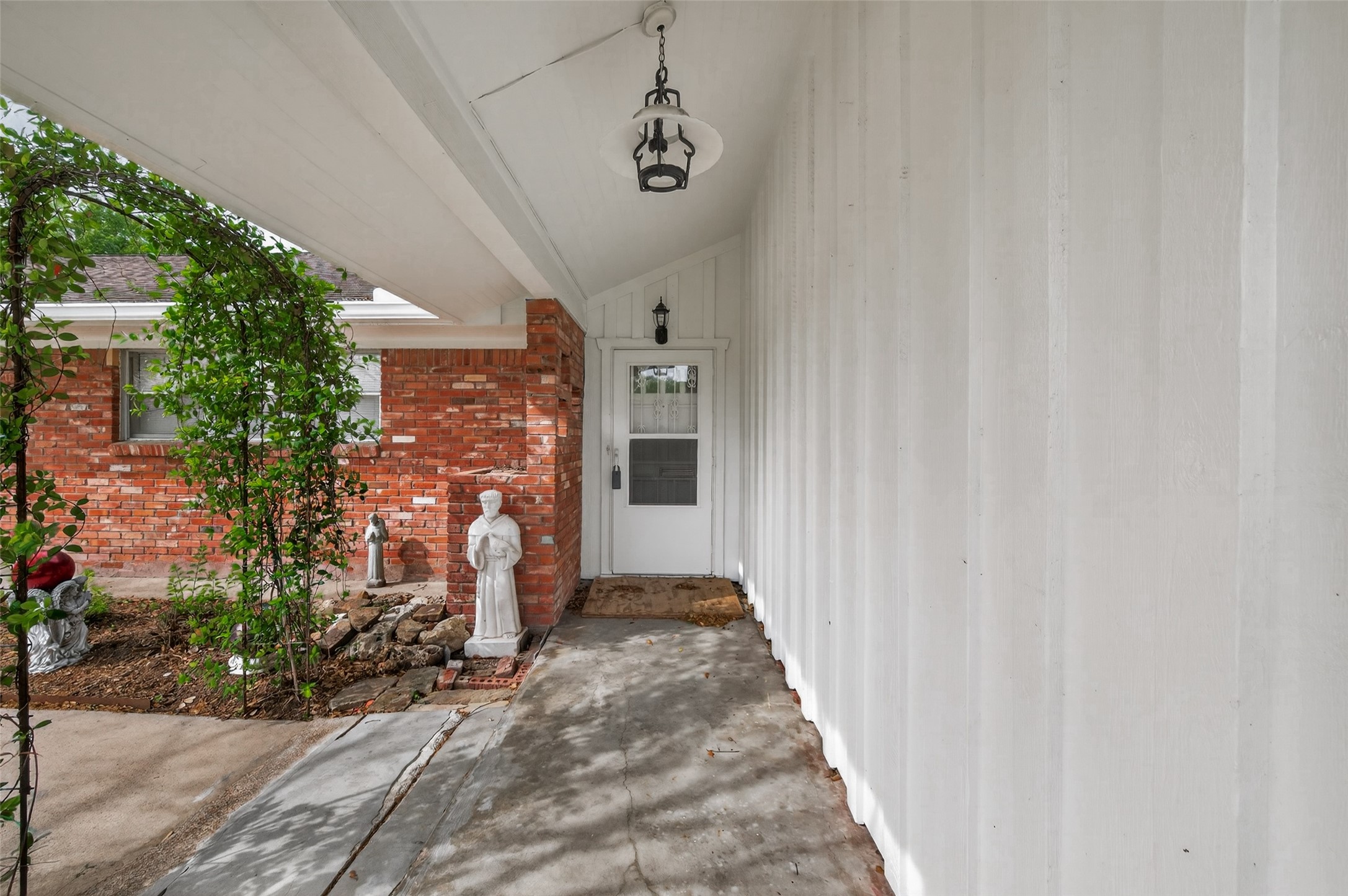 5646 Hazen Street Houston, TX 77081 - Photo 5 of 43 The entryway has a covered porch, a storm door, and brand-new outdoor light fixtures.