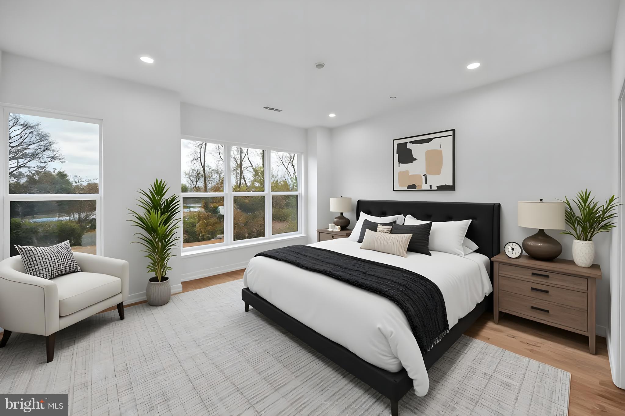 5420 Goshawk Alley Bethesda, MD 20816 - Photo 16 of 57 a spacious bedroom with a bed and a couch