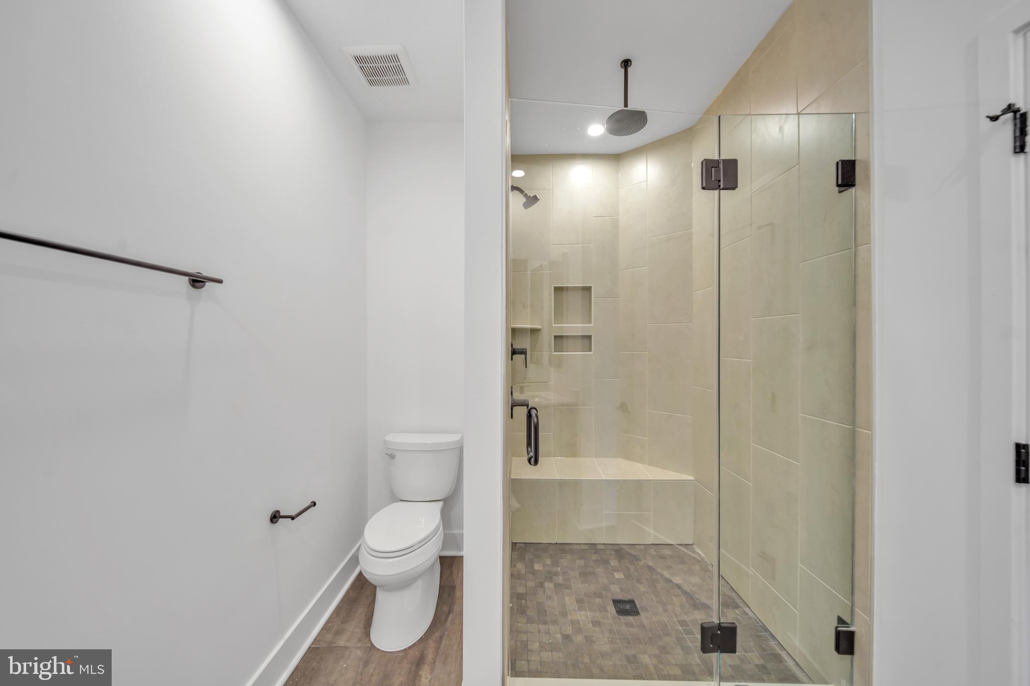 5420 Goshawk Alley Bethesda, MD 20816 - Photo 20 of 57 a bathroom with a shower a toilet and a shower