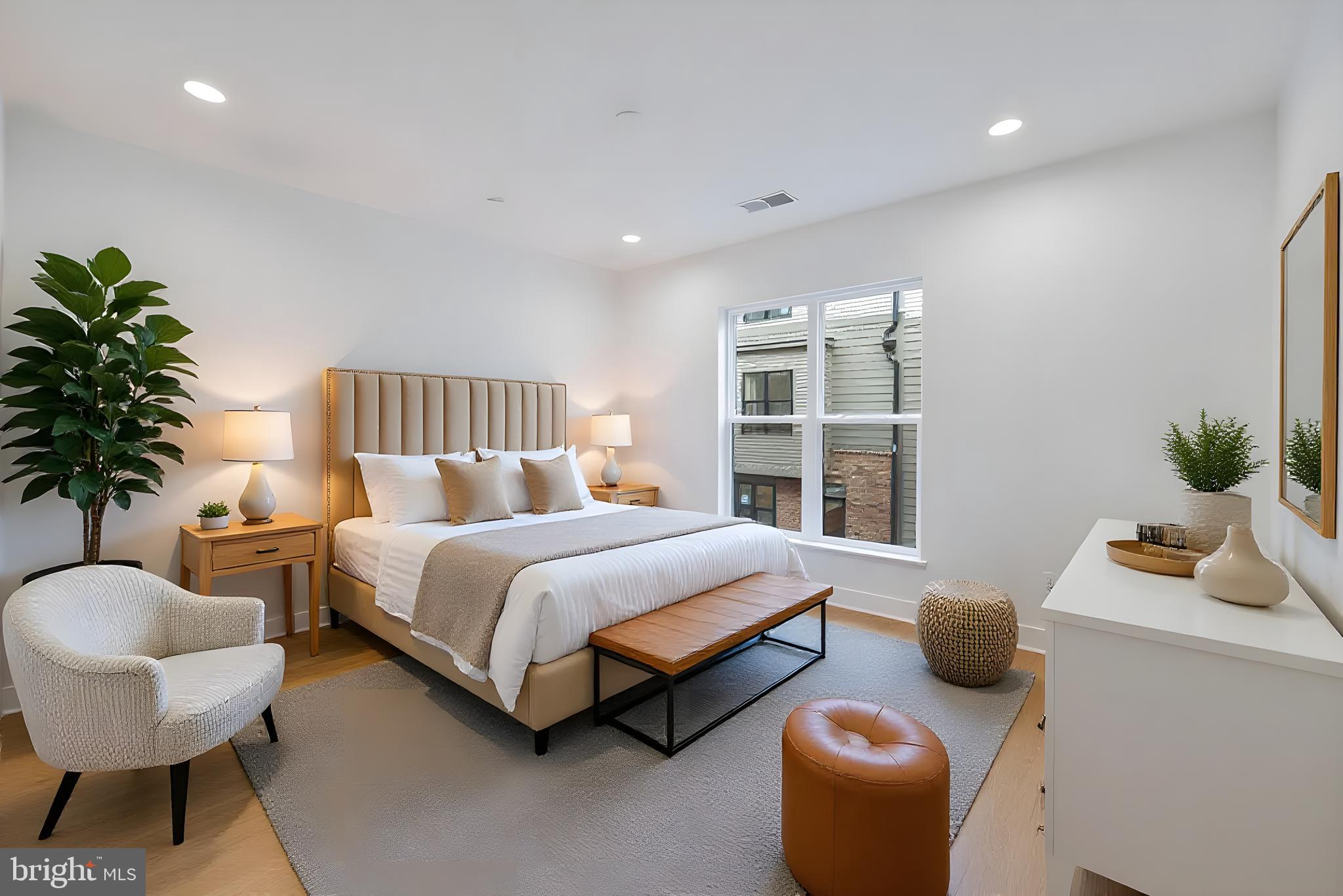 5420 Goshawk Alley Bethesda, MD 20816 - Photo 23 of 57 a bedroom with a bed and a potted plant