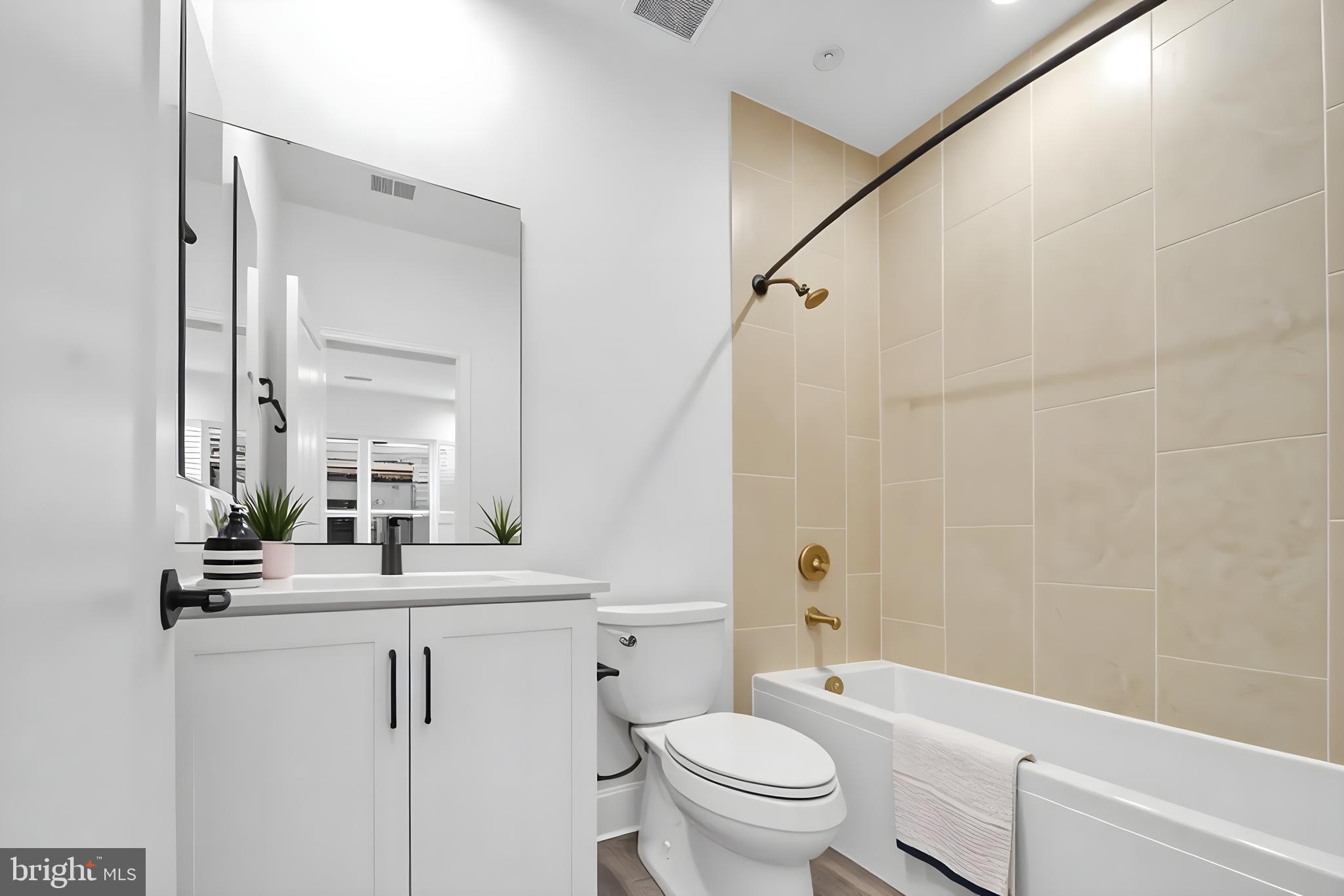 5420 Goshawk Alley Bethesda, MD 20816 - Photo 24 of 57 a bathroom with a sink a toilet and a mirror