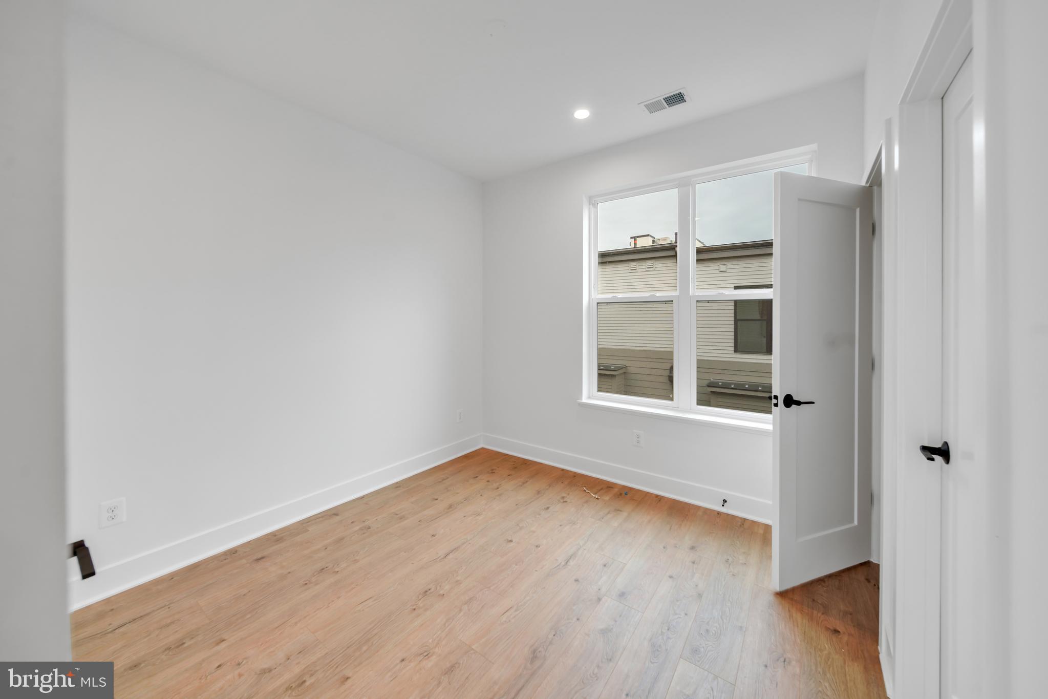 5420 Goshawk Alley Bethesda, MD 20816 - Photo 26 of 57 an empty room with wooden floor and windows