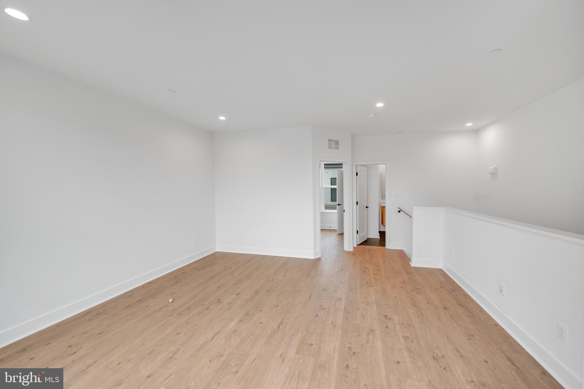 5420 Goshawk Alley Bethesda, MD 20816 - Photo 31 of 57 a view of empty room with wooden floor